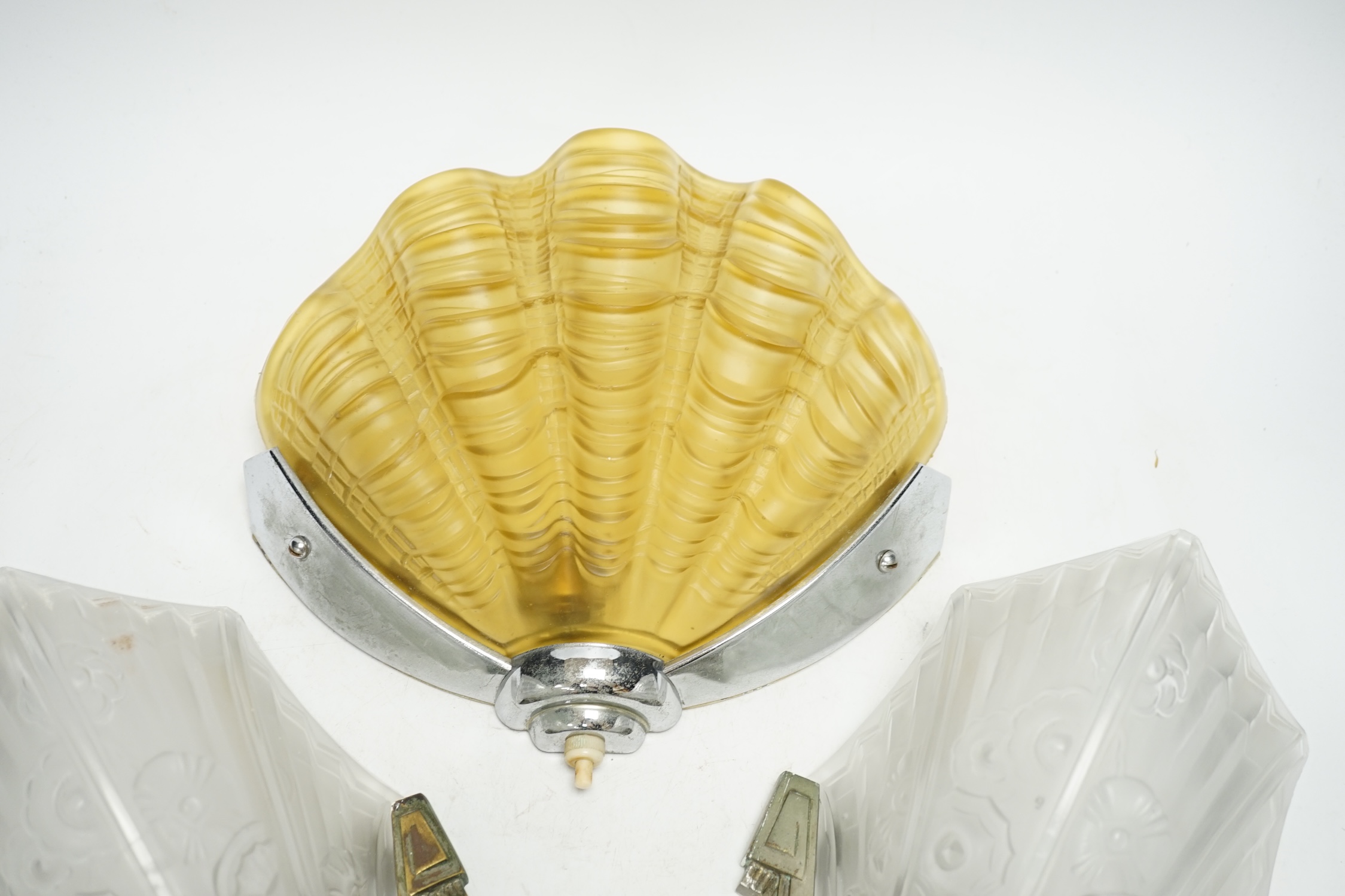 An Art Deco clam shell wall light and a pair of Art Deco wall lights, 30cm high (3). Condition - fair